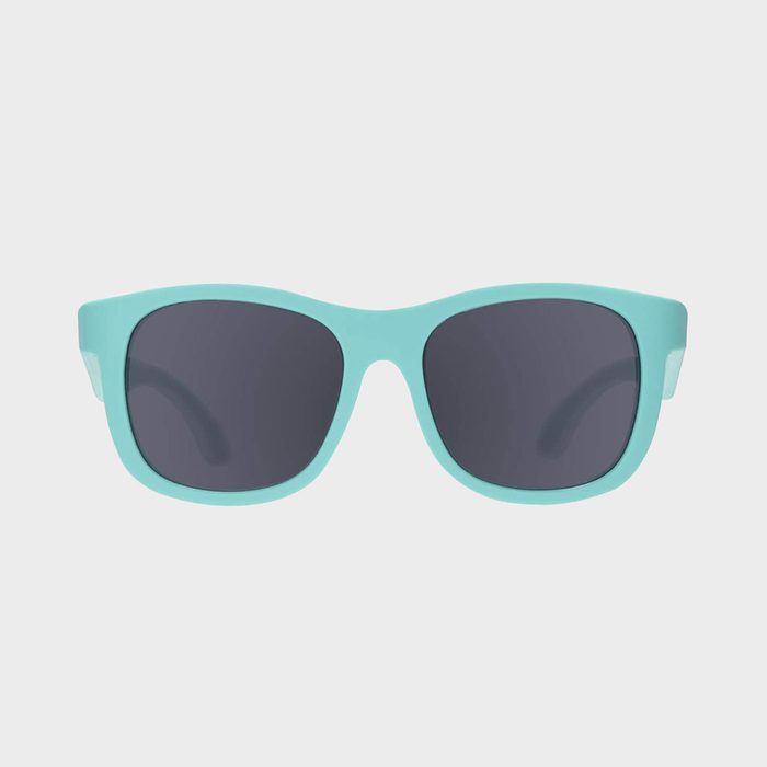 Mint green sunglasses rest on a plain white background.