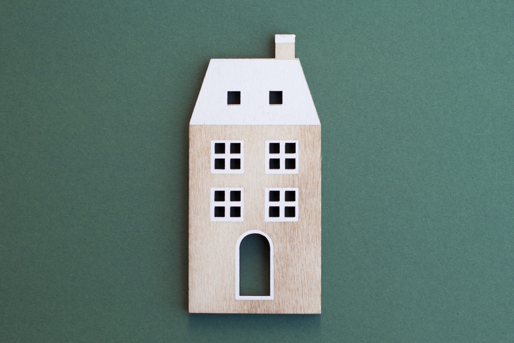 wooden apartment building on green background
