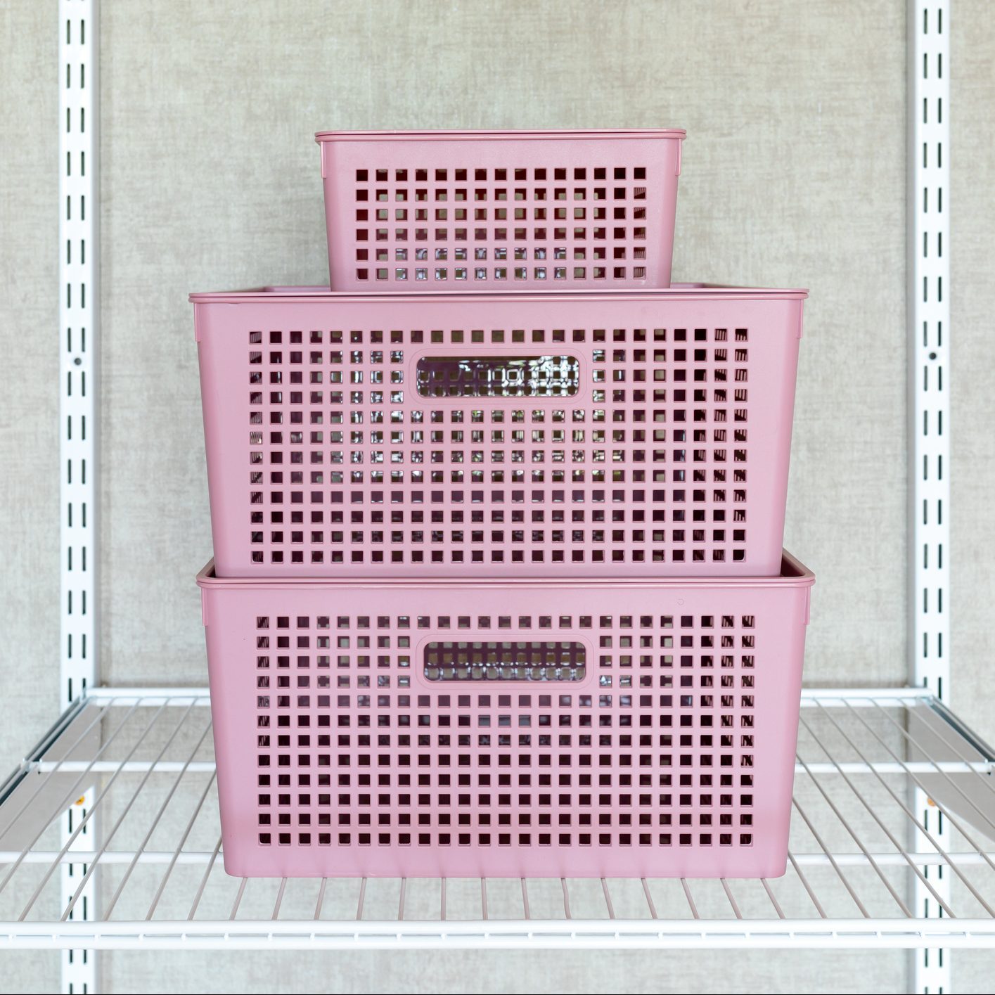 wire closet organizer shelf with stack of plasic bins