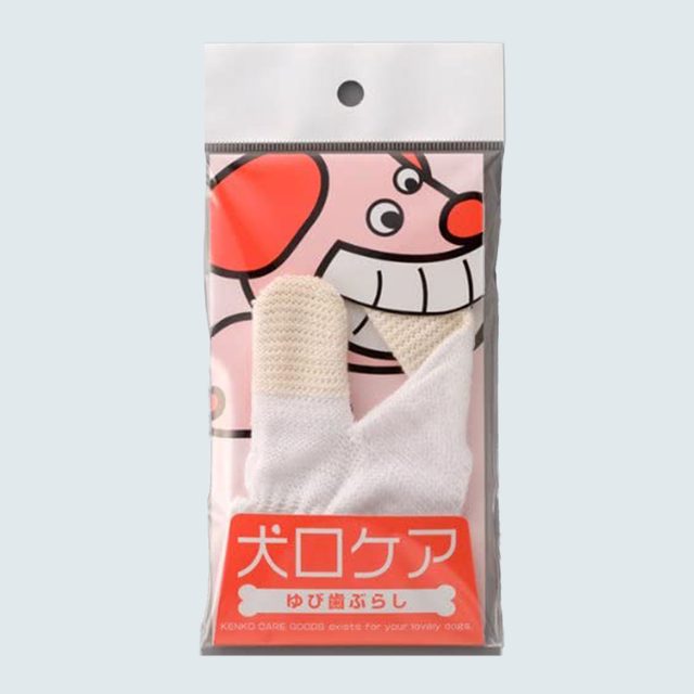 Packaged dental glove displayed against cartoon dog backdrop, features text: 