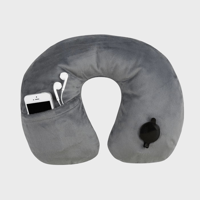 Gray neck pillow with integrated pocket holds a smartphone and earphones; features black inflation valve, set against plain white background.
