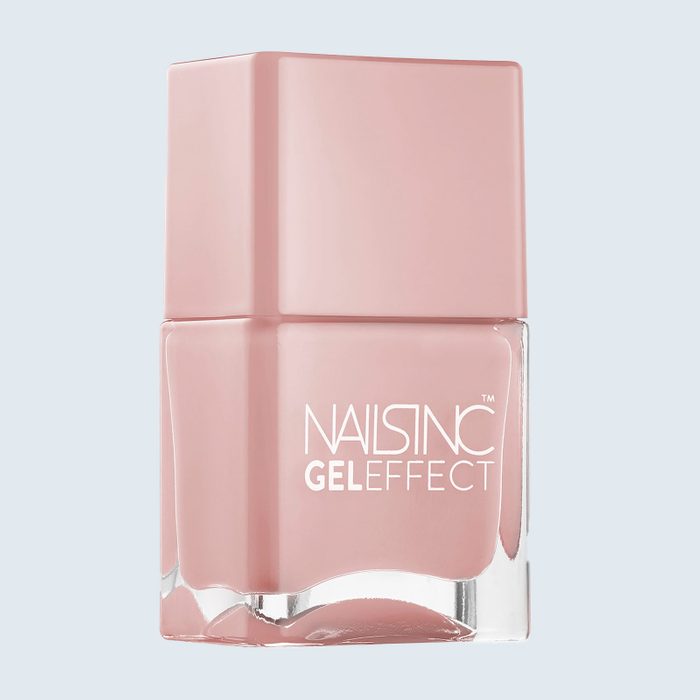 A pink nail polish bottle rests upright. The text on it reads 