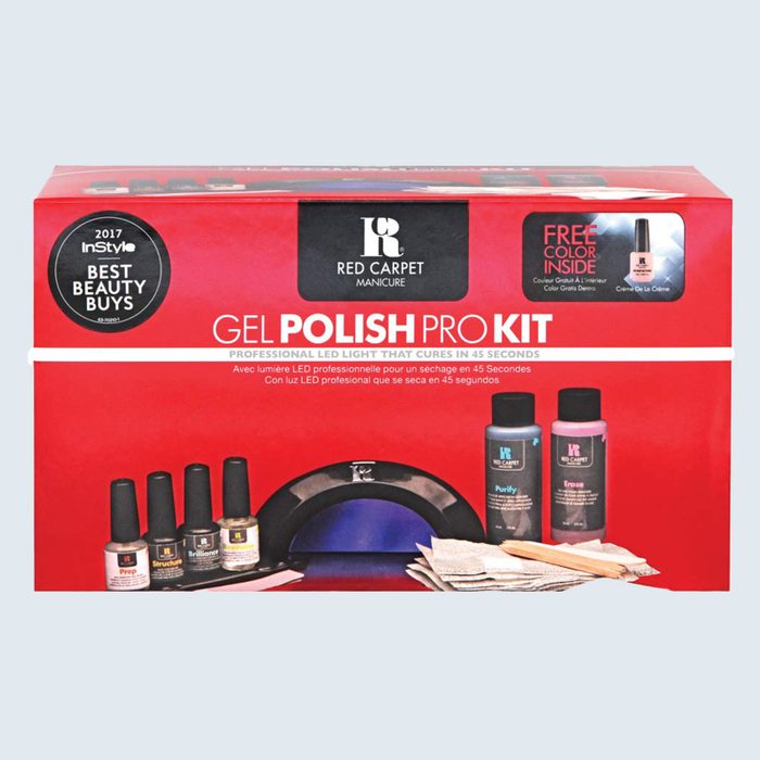 Gel polish kit displayed with bottles, LED light, and accessories, set against a red packaging background. Includes â€œ2017 InStyle Best Beauty Buysâ€ badge.
