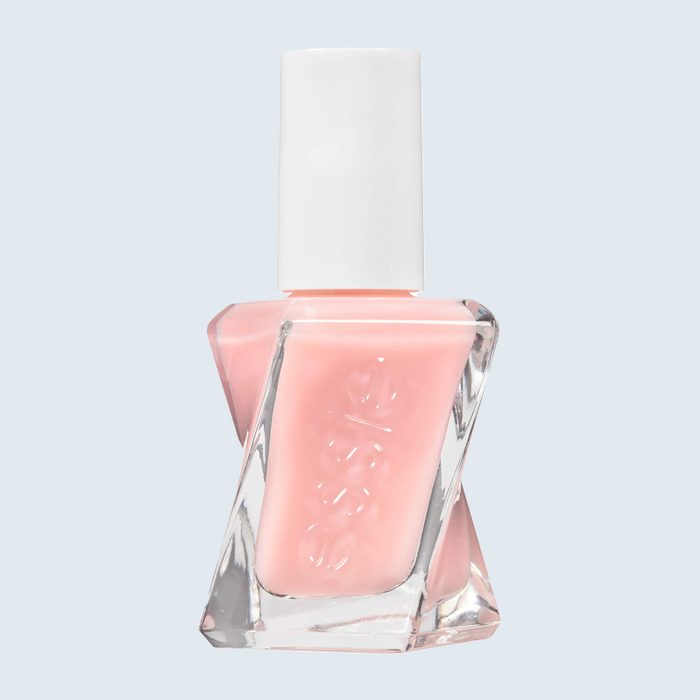 A pink nail polish bottle stands upright against a plain background, featuring a white cap and embossed brand name 