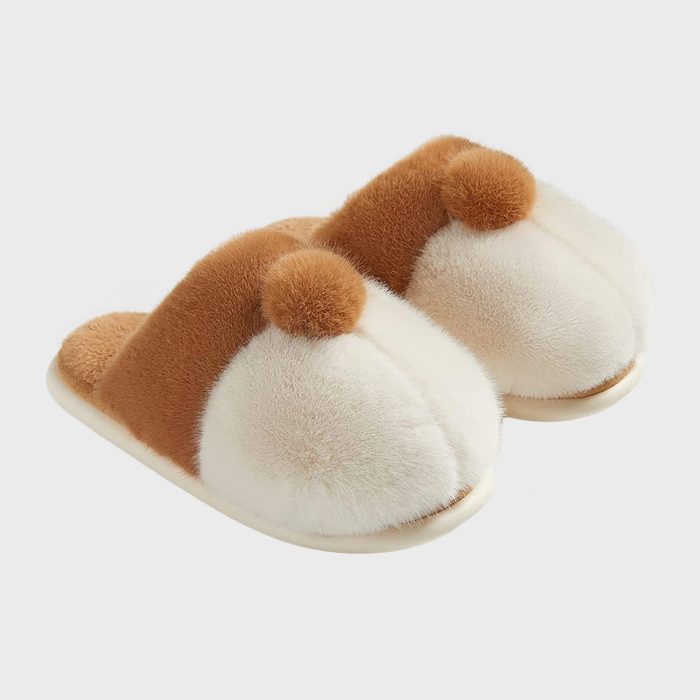 Fluffy slippers with brown and white color blocks rest side by side, featuring pom-pom accents, against a plain white background.
