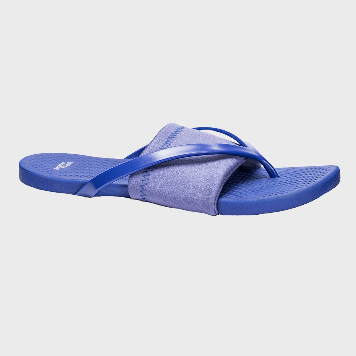 Blue flip-flop with crisscrossing straps rests on a plain white background.