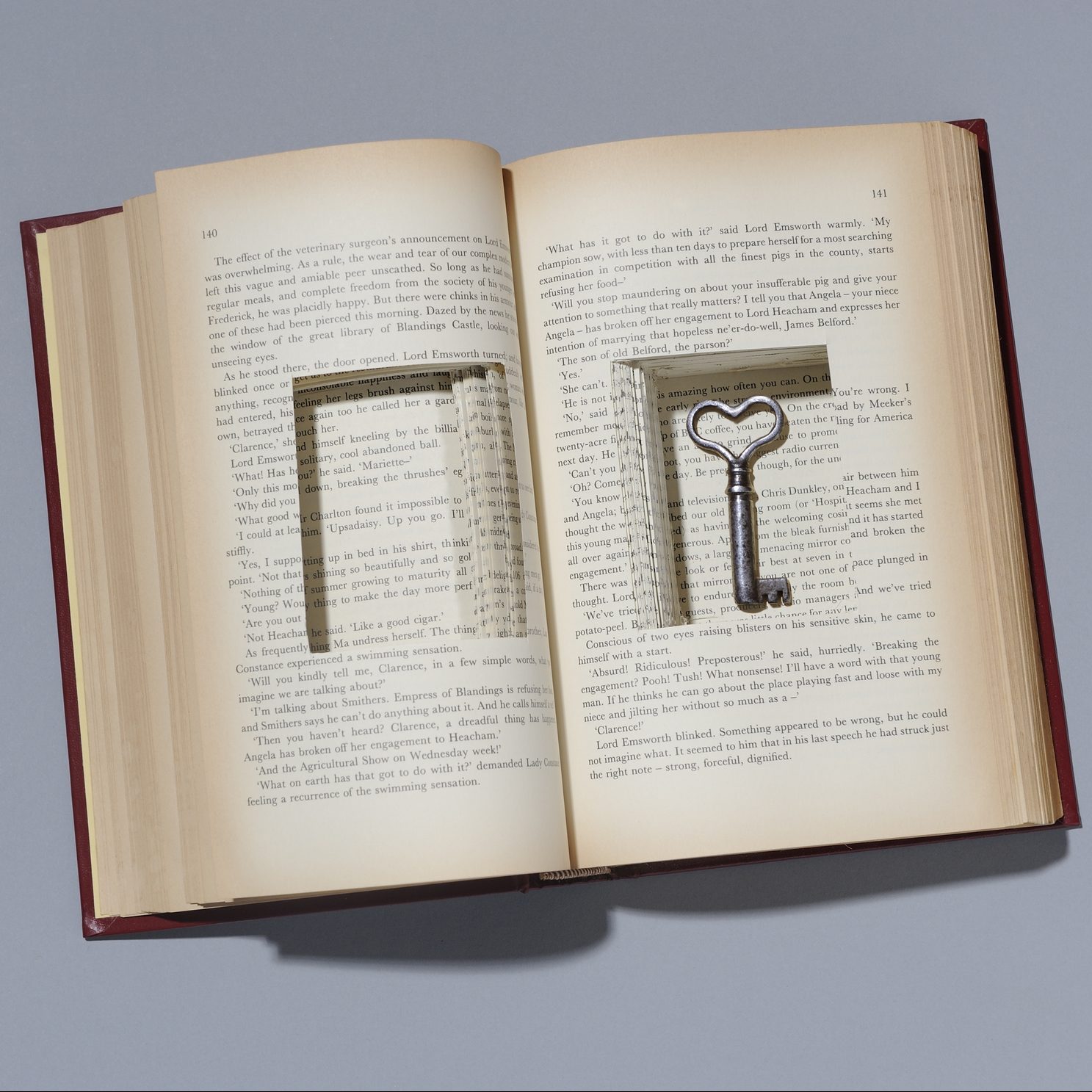 Book with key in cut out compartment.
