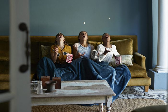 3 friends catching popcorn with the mouth