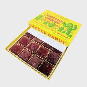 Square candies arranged inside an open yellow box labeled 