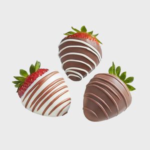 Three strawberries dipped in chocolate with decorative drizzle, displayed on a plain white background.