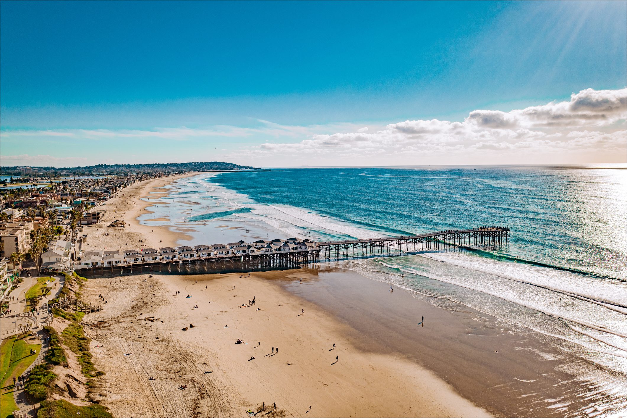 Scenic View Of Beach Against Blue Sky