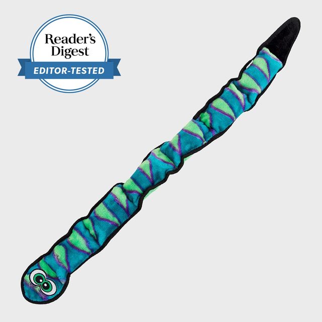 A colorful, segmented dog toy lies flat, displaying bright patterns against a white background. Text reads: 