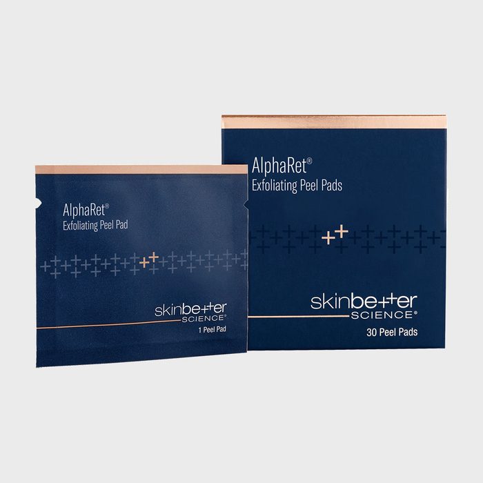 Packets display AlphaRet Exfoliating Peel Pads by skinbetter science, featuring simple packaging design with navy and copper accents, against a plain background.
