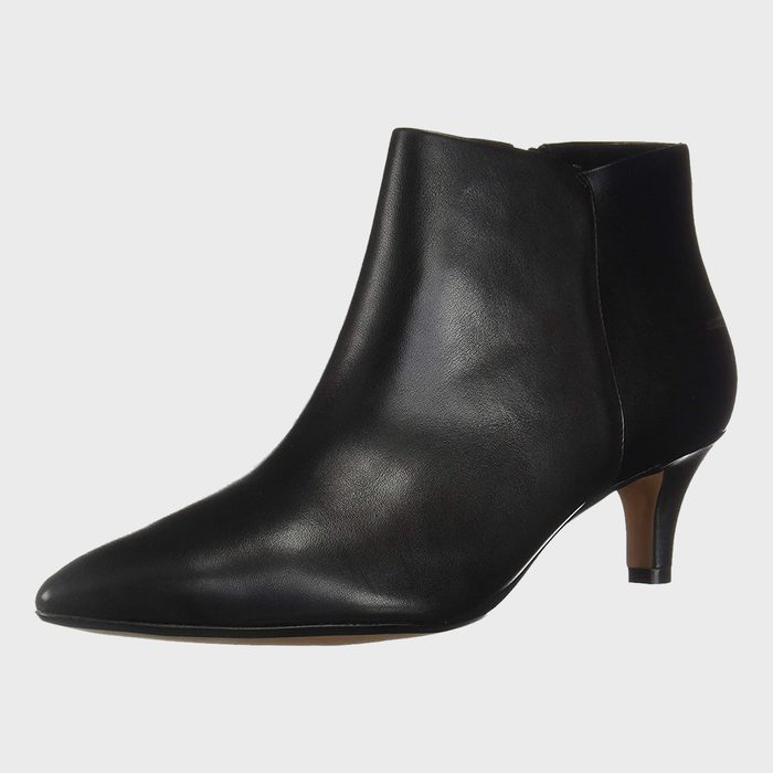 A sleek black leather ankle boot with a low heel is photographed against a plain white background.
