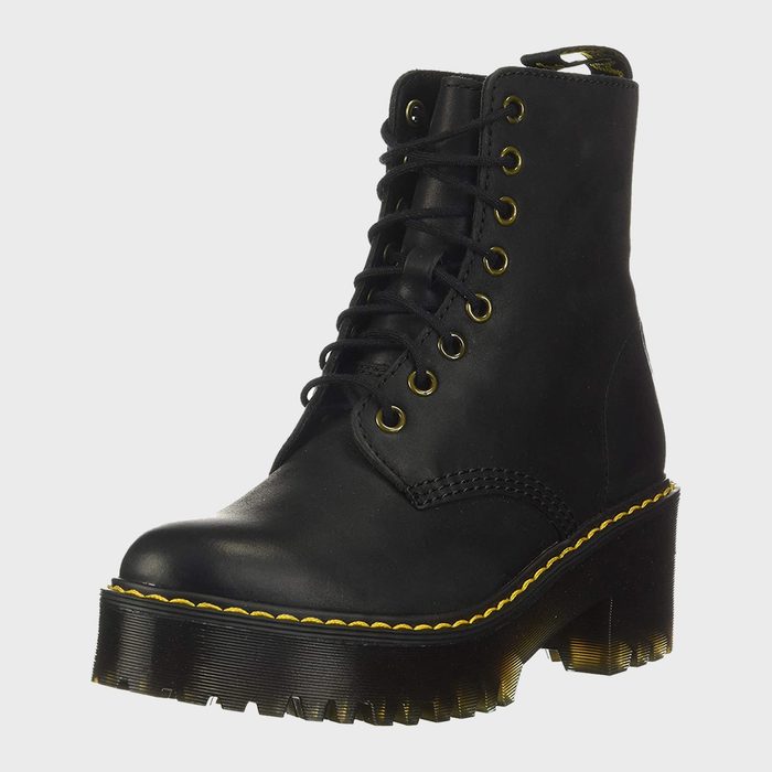 Black leather boot with yellow stitching, features thick lug sole and eight eyelets, seen in a plain, light-colored background.