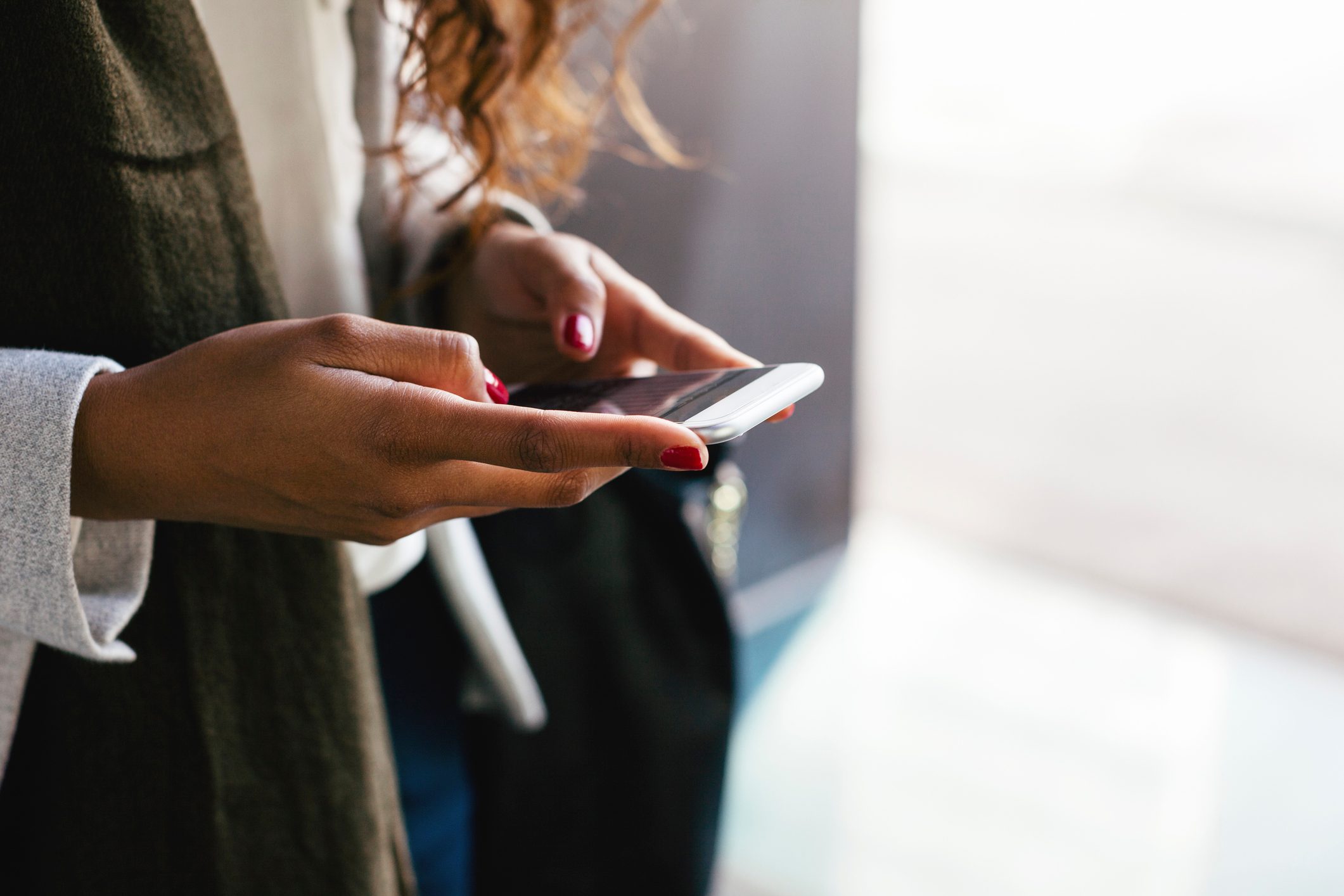 close up of woman holding smartphone