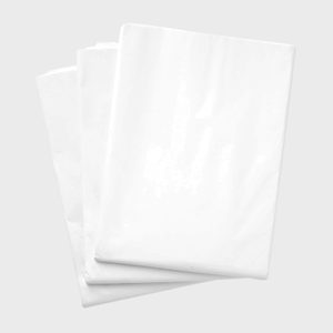 Three white plastic bags are stacked, lying flat, on a plain gray background.