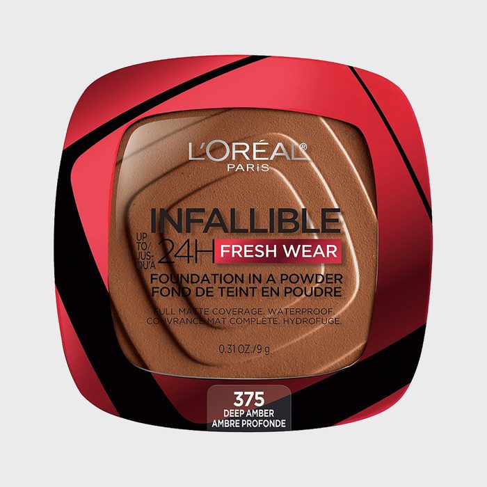 Compact powder sits in red-black container, labeled 