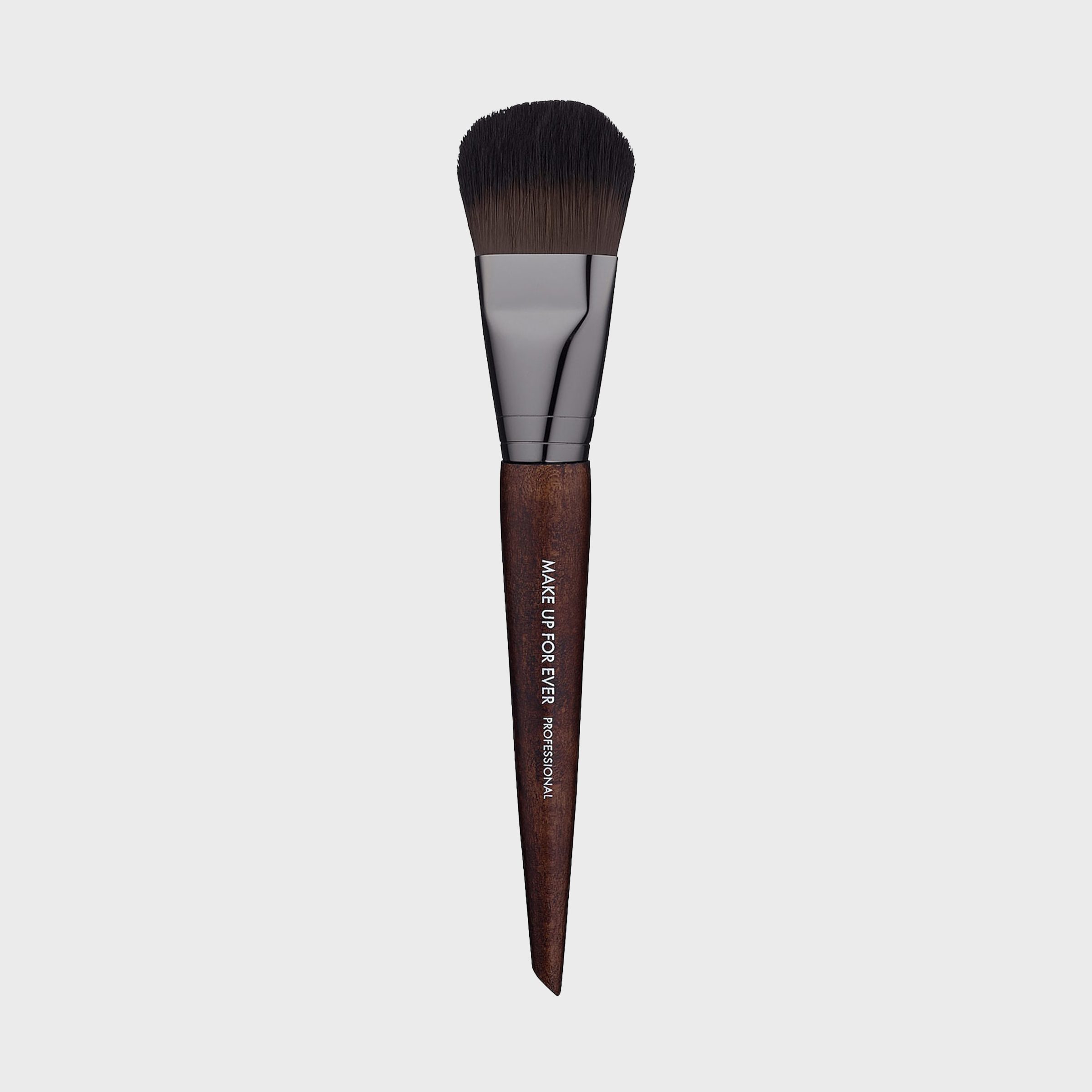 Makeup brush resting against a plain background; brown wooden handle engraved with "MAKE UP FOR EVER PROFESSIONAL," black bristles with sleek metal ferrule.