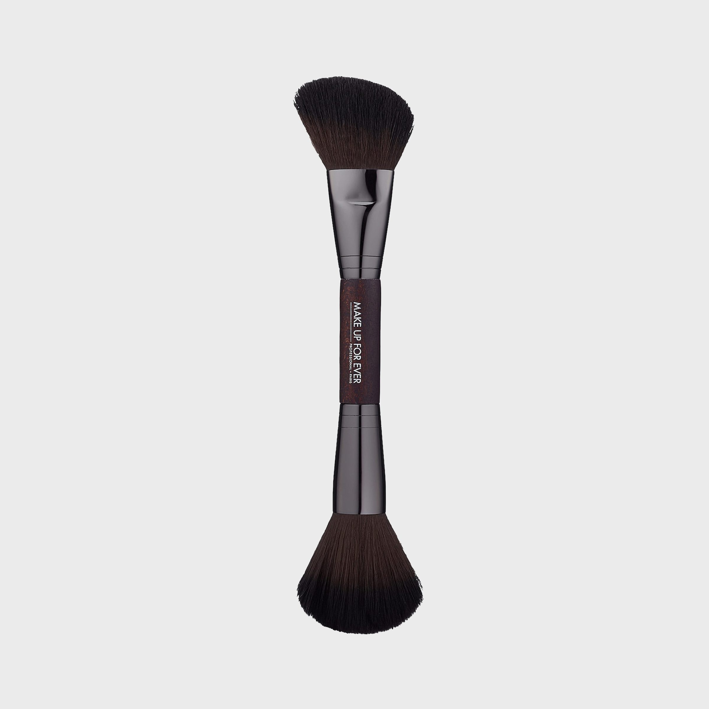 Dual-ended makeup brush; bristles facing outward. "Make Up For Ever" text on handle. Set against a plain white background.