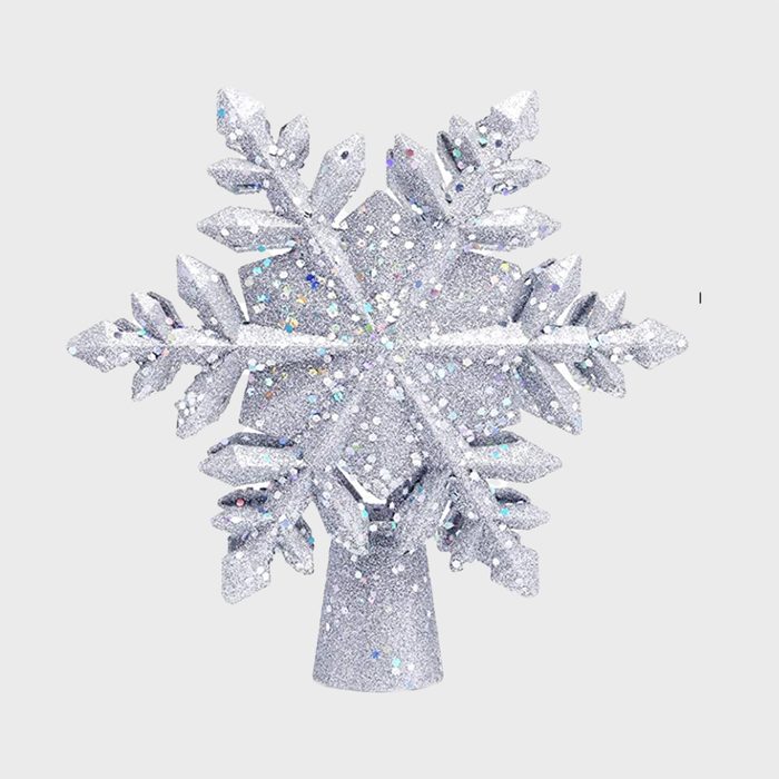 Silver glittery snowflake ornament, resting upright, against a plain white background.
