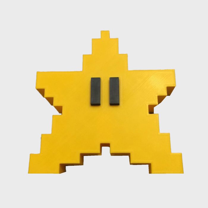 Yellow pixelated star with two black rectangular eyes, resting against a plain white background.