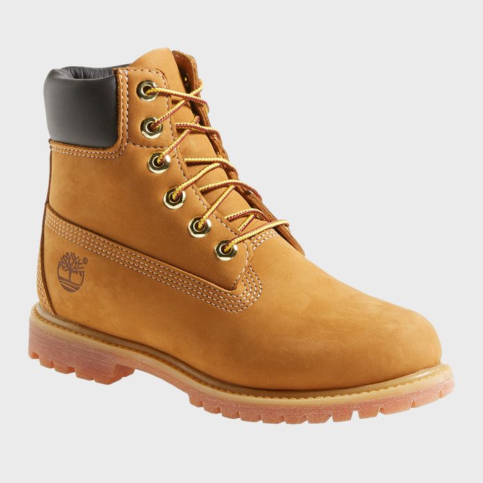 Tan leather boot with gold eyelets and yellow-brown laces, standing on a white background, displaying a tree logo on the side.