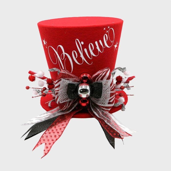 Red top hat decorated with a bow and festive accents, displaying the word 