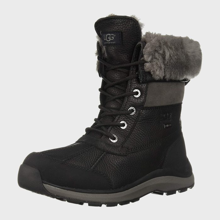A black leather winter boot with laces and gray fur lining, displayed against a plain background. 