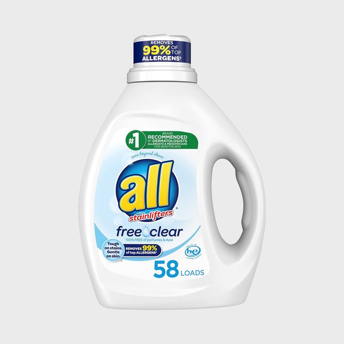 Detergent bottle displays branding and text about allergen removal on a clean, simple background. Transcribed text: 