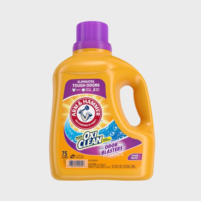 A yellow detergent bottle with a purple cap stands alone, featuring 
