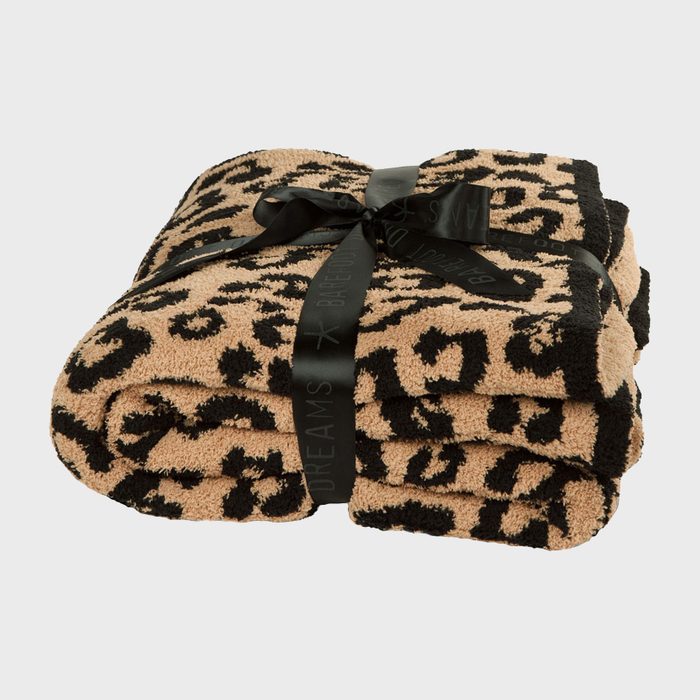 Leopard-print blanket, neatly folded, tied with a black ribbon featuring the text 