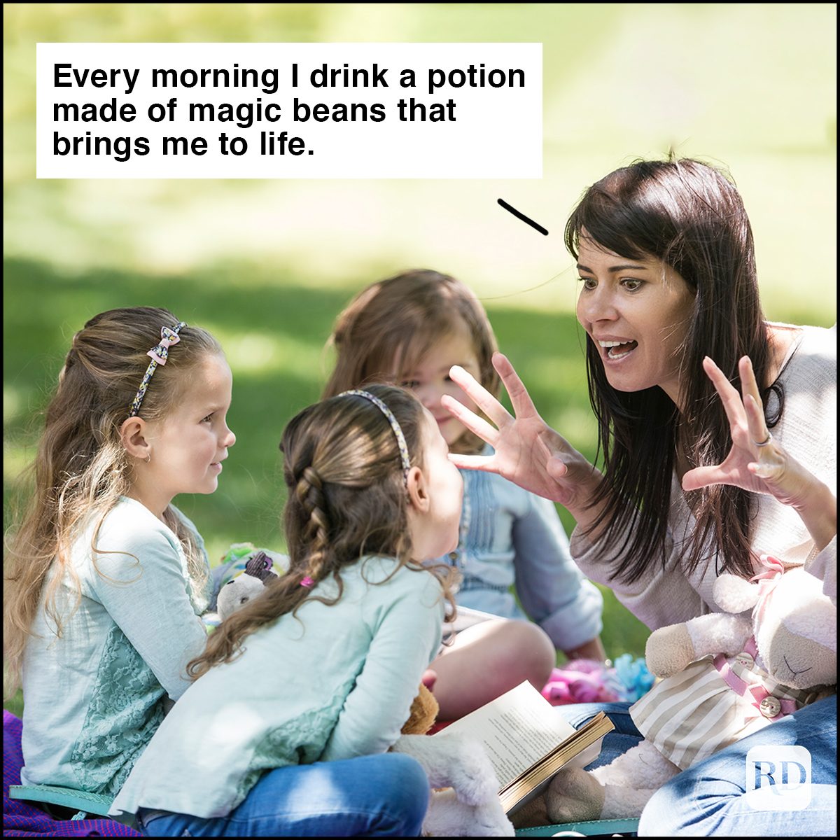 Mother telling stories to children on picnic blanket