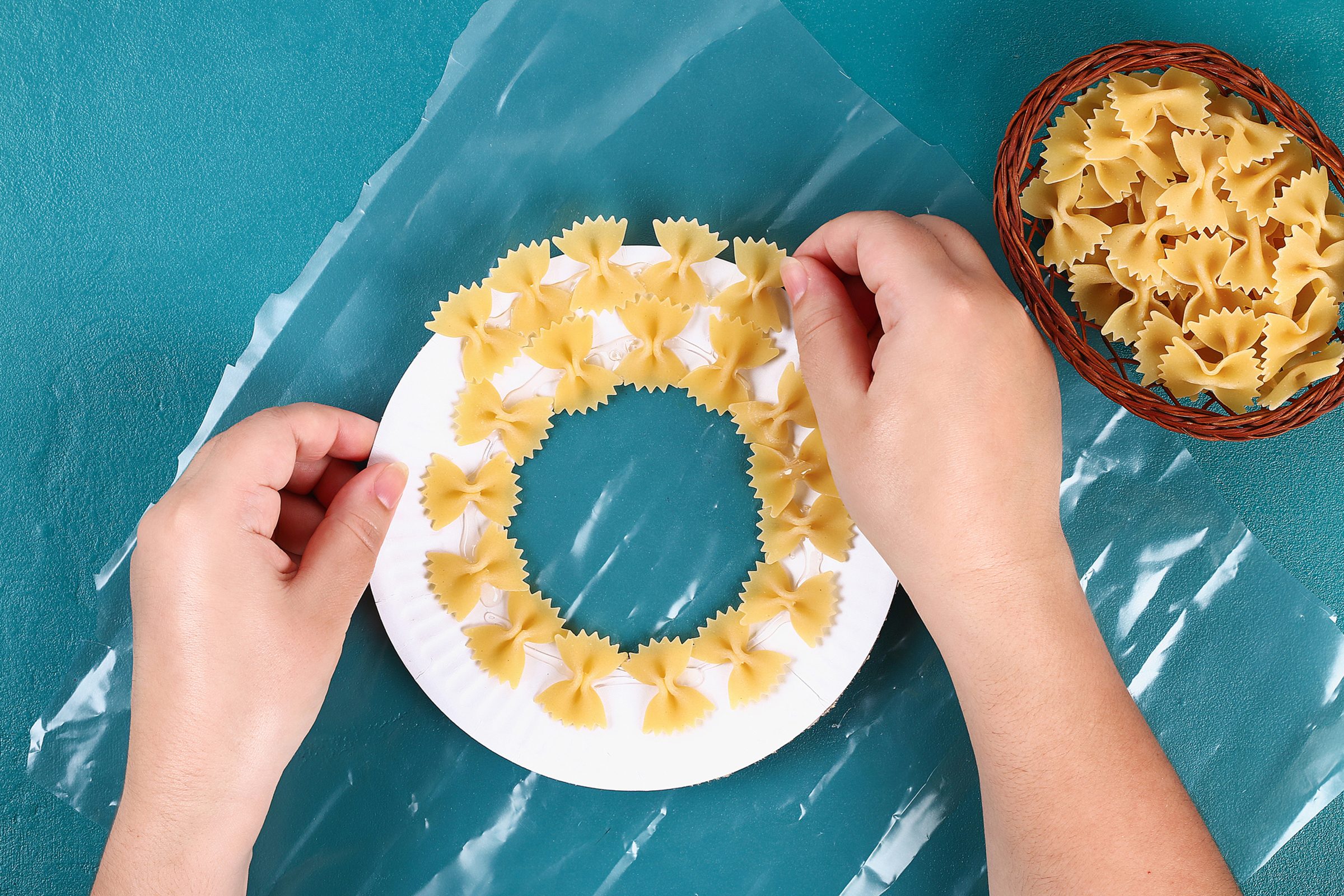 Diy Christmas pasta wreath on blue background