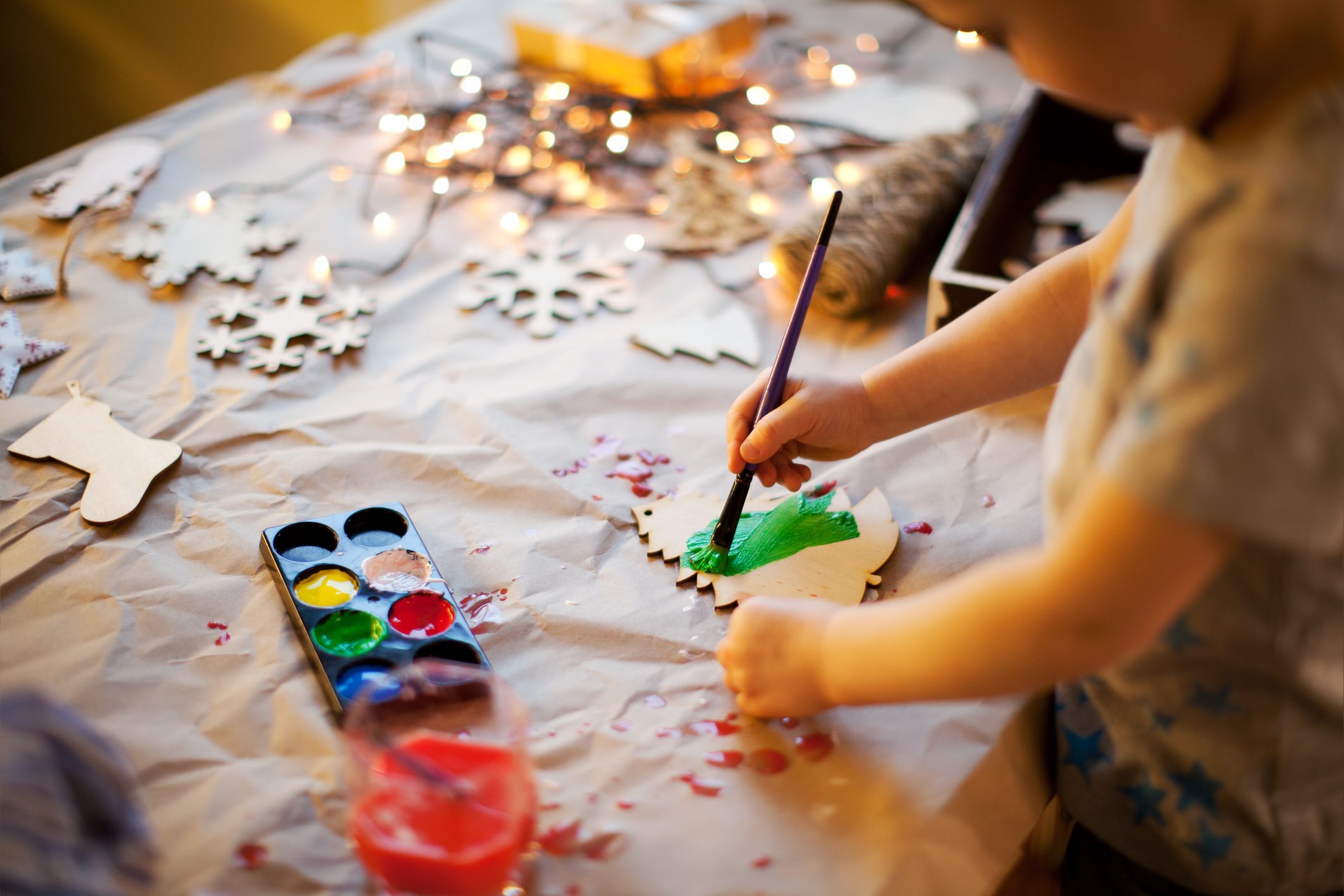 young child making christmas crafts