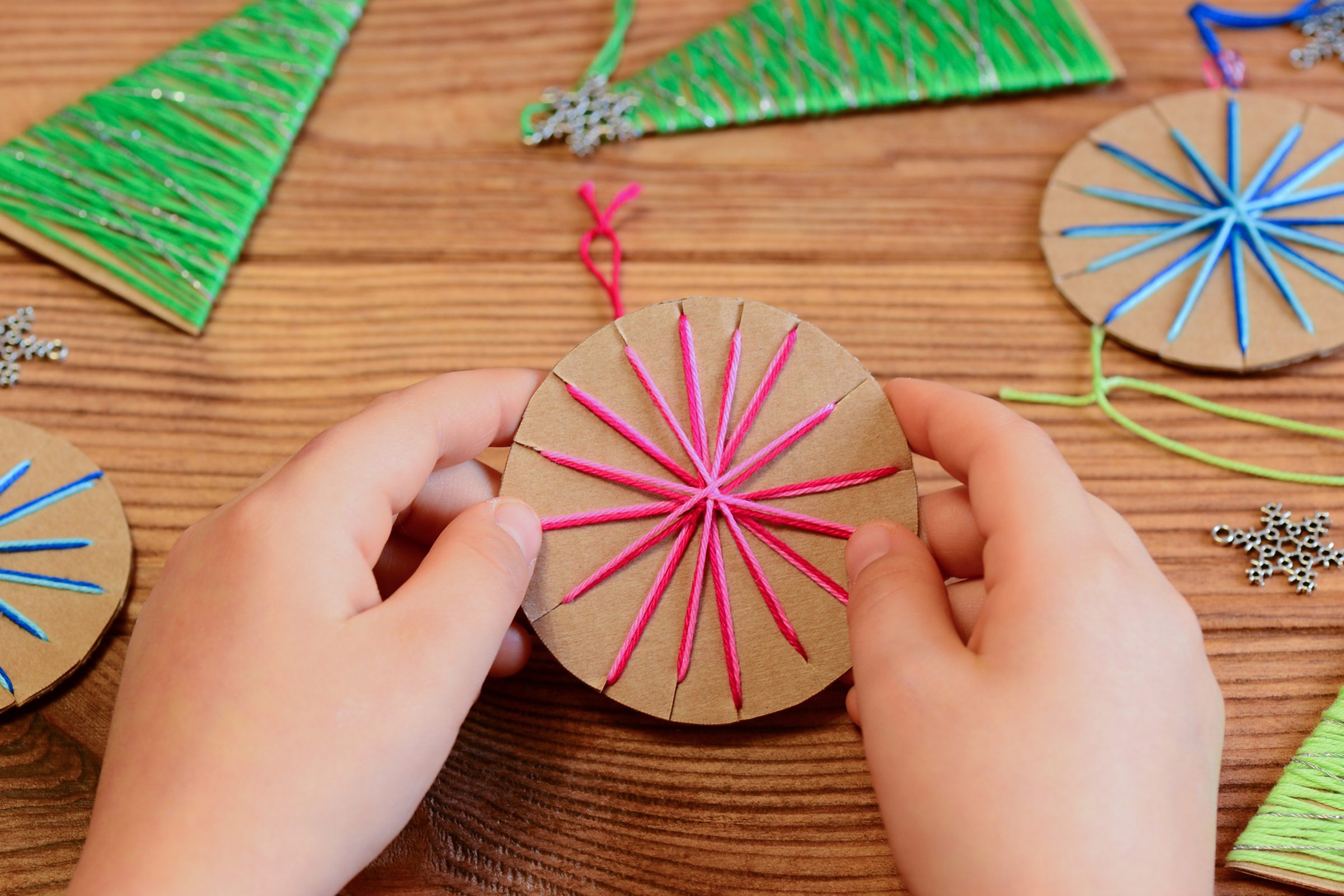 Child is holding a Christmas ball in his hands