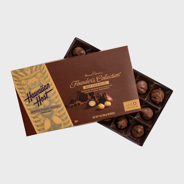 Box holds milk chocolates, revealing a tray of chocolates. Brown packaging reads 