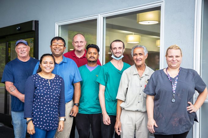 Some of the the crew pose for a photo at the Quality Inn in Kodak, Tenn.