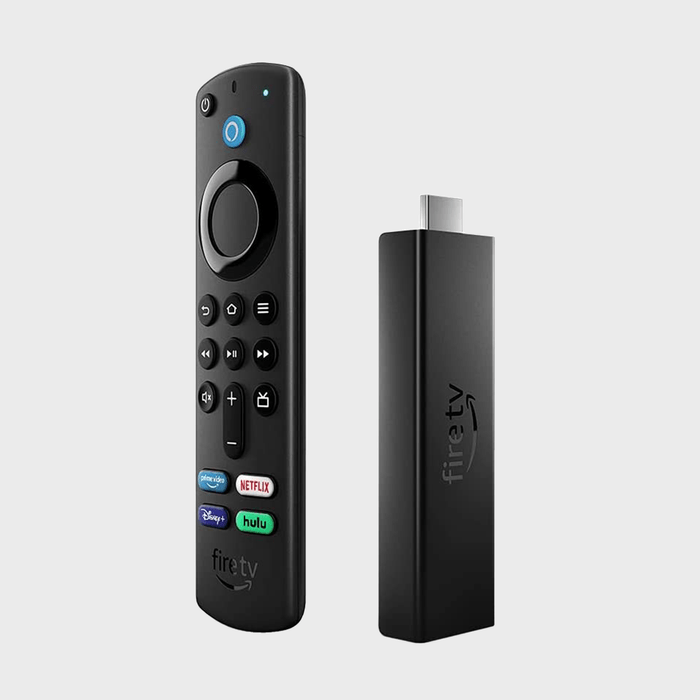 Remote and media stick stand upright, displaying buttons for streaming services. Set against a plain background.