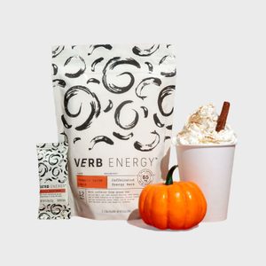 Energy bars package stands upright, displaying design; small pumpkin and topped drink cup beside it illustrate autumn theme. Text: 