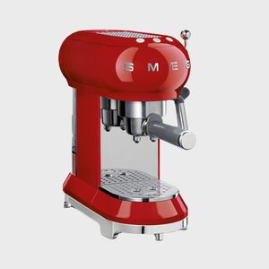 Red espresso machine sits on a surface, displaying 