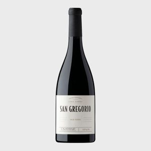 A wine bottle stands upright; label reads 