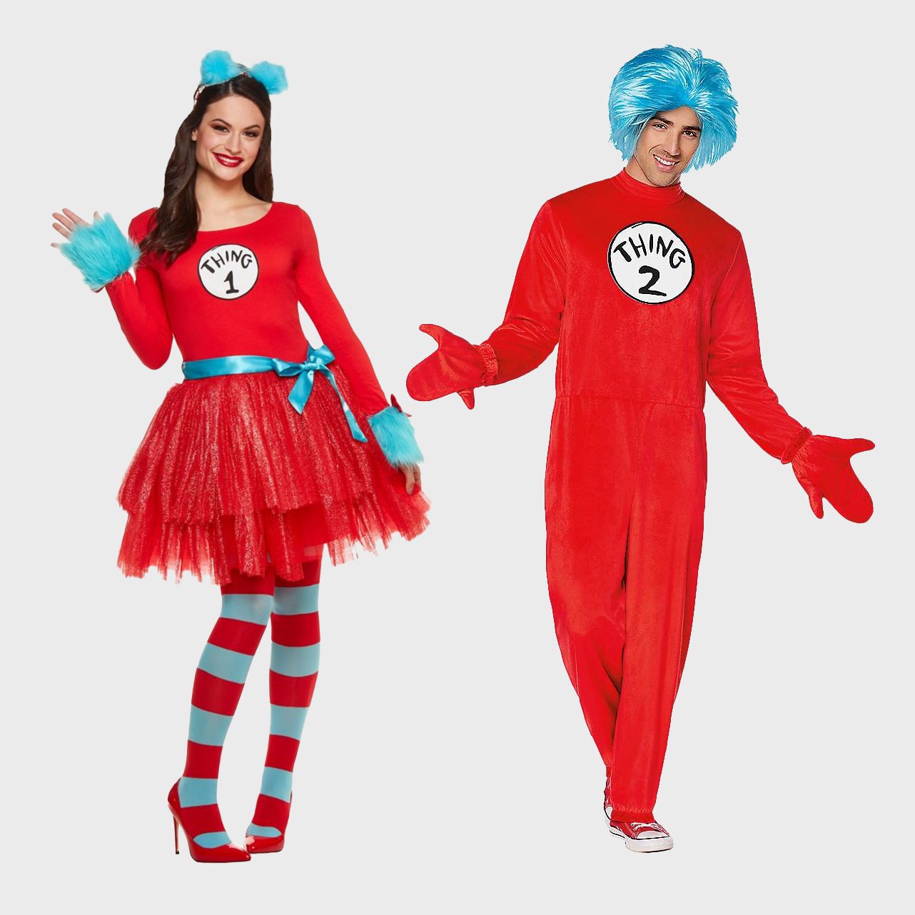 Two people wear red "Thing 1" and "Thing 2" costumes, smiling and posing together. The outfits include blue wigs and colorful striped accessories.