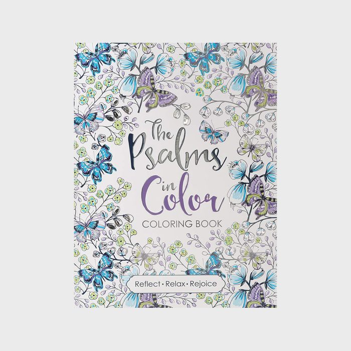 Coloring book lies surrounded by floral and butterfly patterns; text reads 