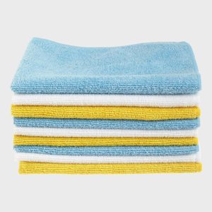 Stacked towels alternate in blue, white, and yellow hues against a plain white background.