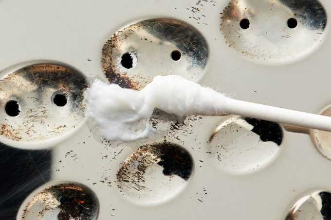 Cleaning Iron With Cotton Swab and toothpaste