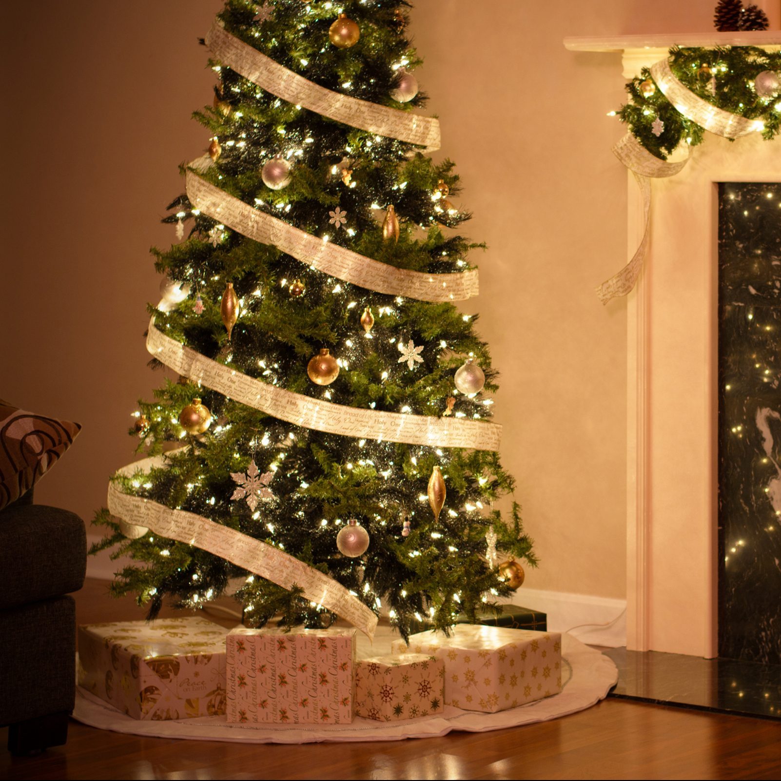 Christmas Tree with gold bow decoration around it.