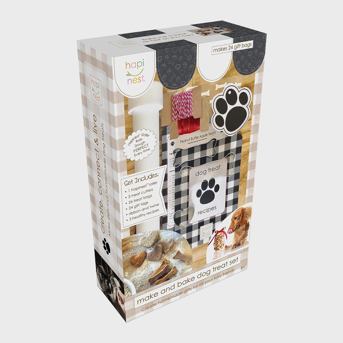 Box containing a dog treat baking set with accessories, displayed against a checkered background, featuring paw prints and treat illustrations.