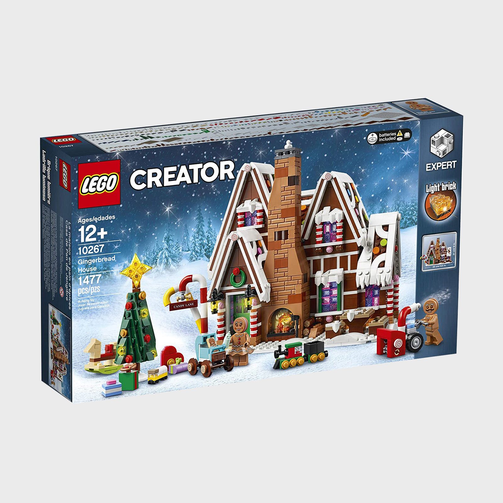 LEGO set box shows a gingerbread house in snowy scenery with Christmas tree, gifts, and gingerbread figures. Contains 1,477 pieces, ages 12+.