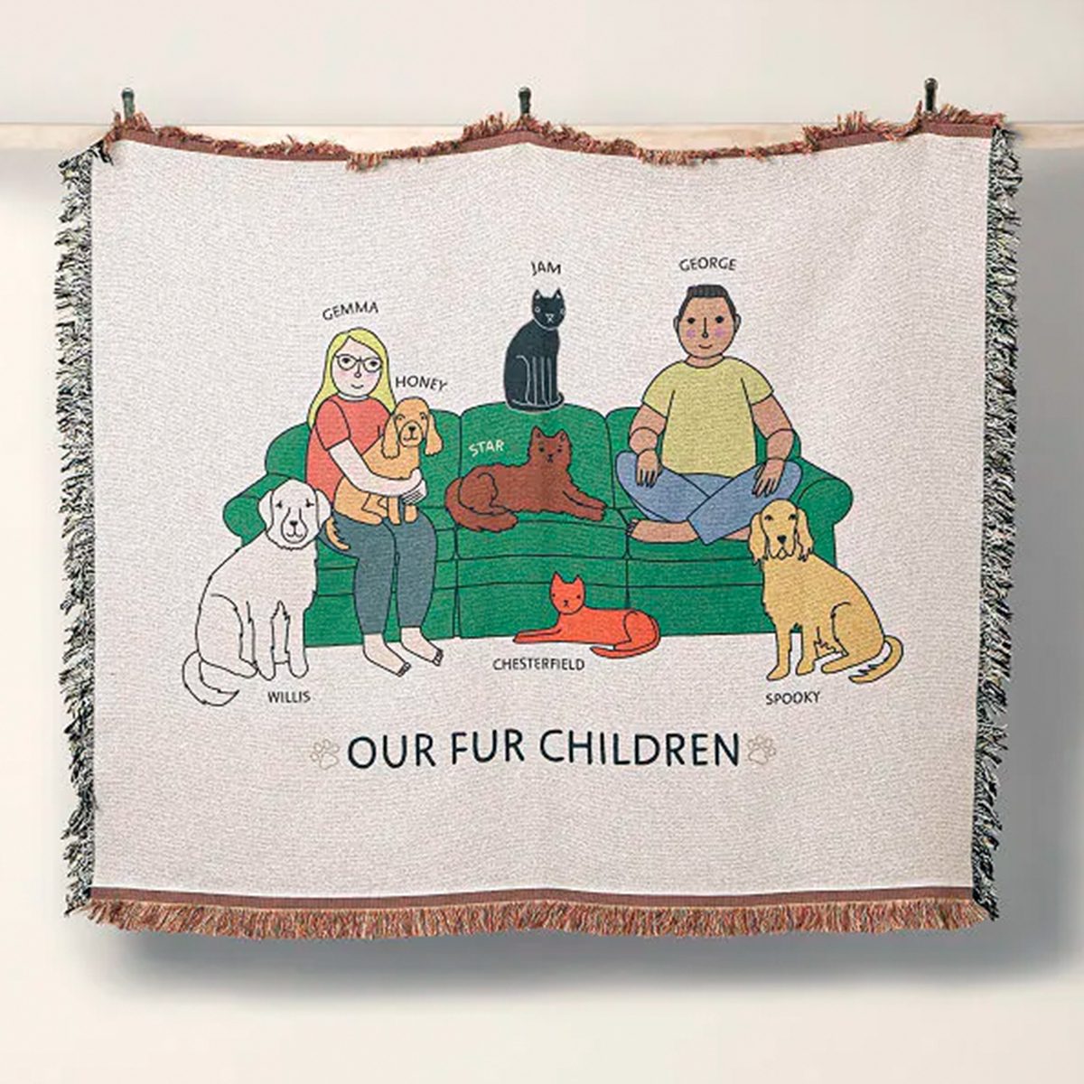 Cartoon people and pets sit on a couch in a woven tapestry; labeled "OUR FUR CHILDREN." Six animals surround two sitting individuals.